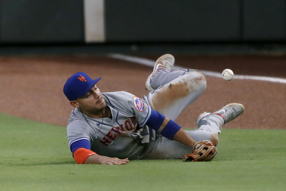 New York Mets right fielder Michael Conforto dives for a ball hit for a double by Atlanta Braves' Ender Inciarte in the seventh inning of a baseball game Monday, Aug. 3, 2020, in Atlanta. (AP Photo/John Bazemore)