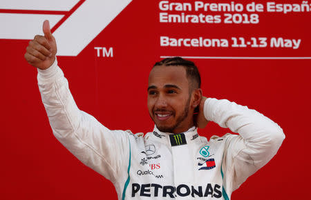 Formula One F1 - Spanish Grand Prix - Circuit de Barcelona-Catalunya, Barcelona, Spain - May 13, 2018 Mercedes’ Lewis Hamilton celebrates on the podium after winning the race REUTERS/Juan Medina