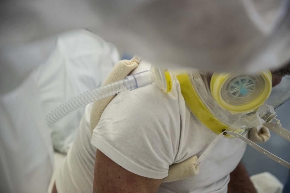 A patient is visited in the emergency COVID-19 ward at the Mellino Mellini hospital in Chiari, northern Italy, Monday, March 8, 2021. The 160-bed hospital in the Po River Valley town of Chiari has no more beds for patients stricken with the highly contagious variant of COVID-19 first identified in Britain, and which now has put hospitals in Italy’s northern Brescia province on high alert. (AP Photo/Luca Bruno)