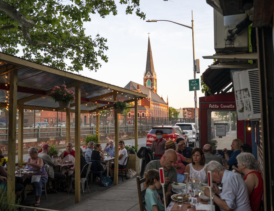 NEW YORK, NY - JUNE 05: People sit outdoors at the Petite Crevette Restaurant on June 05, 2021 in the Brooklyn borough of New York City. Like much of the nation, New York City is quickly starting to re-open as more and more Americans receive the vaccination for Covid-19. (Photo by Robert Nickelsberg/Getty Images)