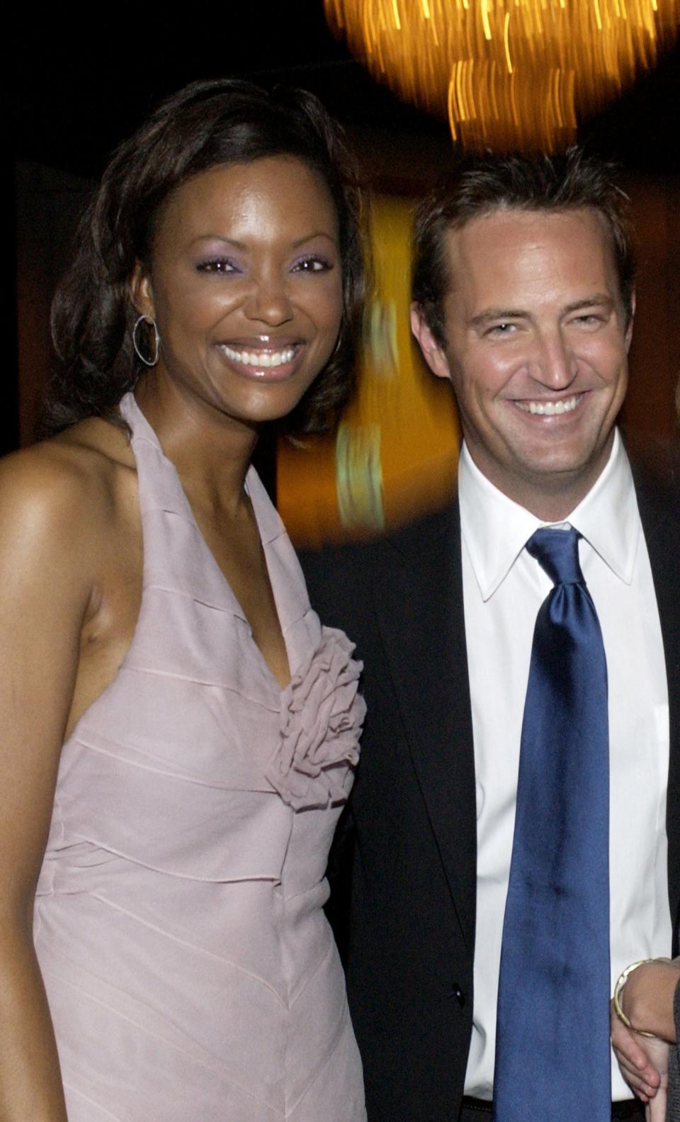 Closeup of Aisha Tyler and Matthew Perry