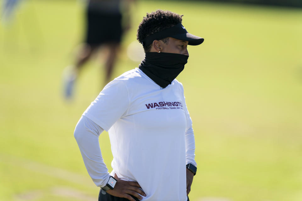 FILE - In this Aug. 18, 2020, file photo, Washington full-year coaching intern Jennifer King watches practice at the team's NFL football training facility in Ashburn, Va. For the first time in NFL history, there will be two female coaches on the sideline and a female official on the field when the Browns host the Washington Football team. King is in her first season on Washington’s staff while Callie Brownson is the chief of staff for Browns first-year coach Kevin Stefanski. Sarah Thomas became the league’s first female official in 2015, has worked in the postseason and is now making more history. (AP Photo/Alex Brandon, File)