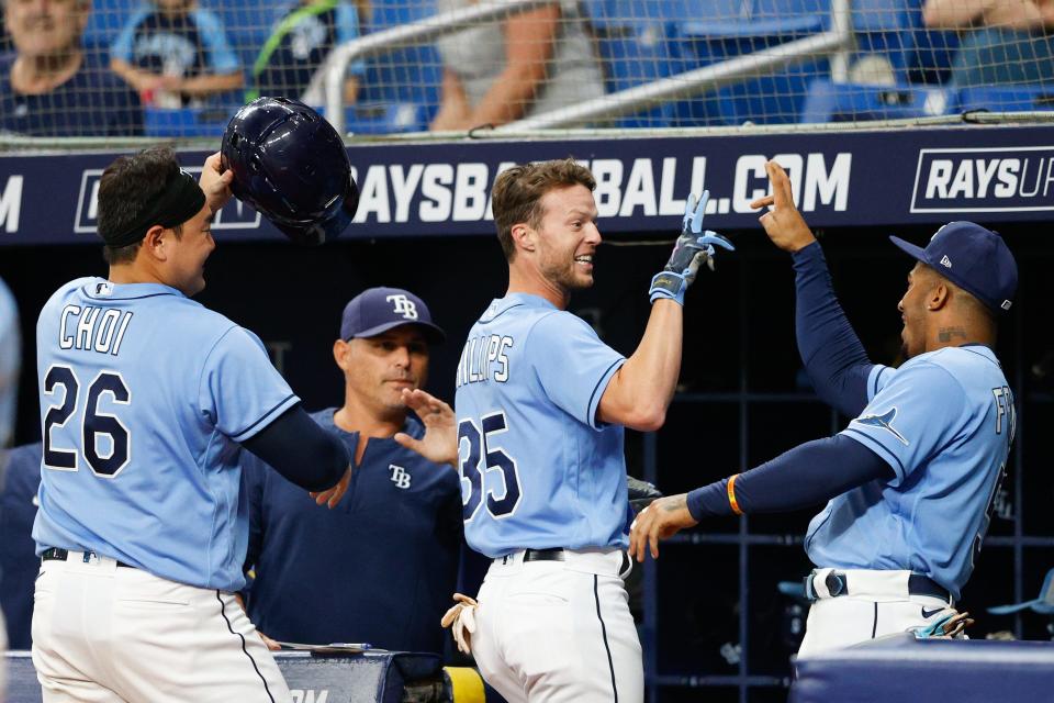 Tampa Bay Rays right fielder Brett Phillips (left)  is congratulated after hitting a home run against the Oakland Athletics.