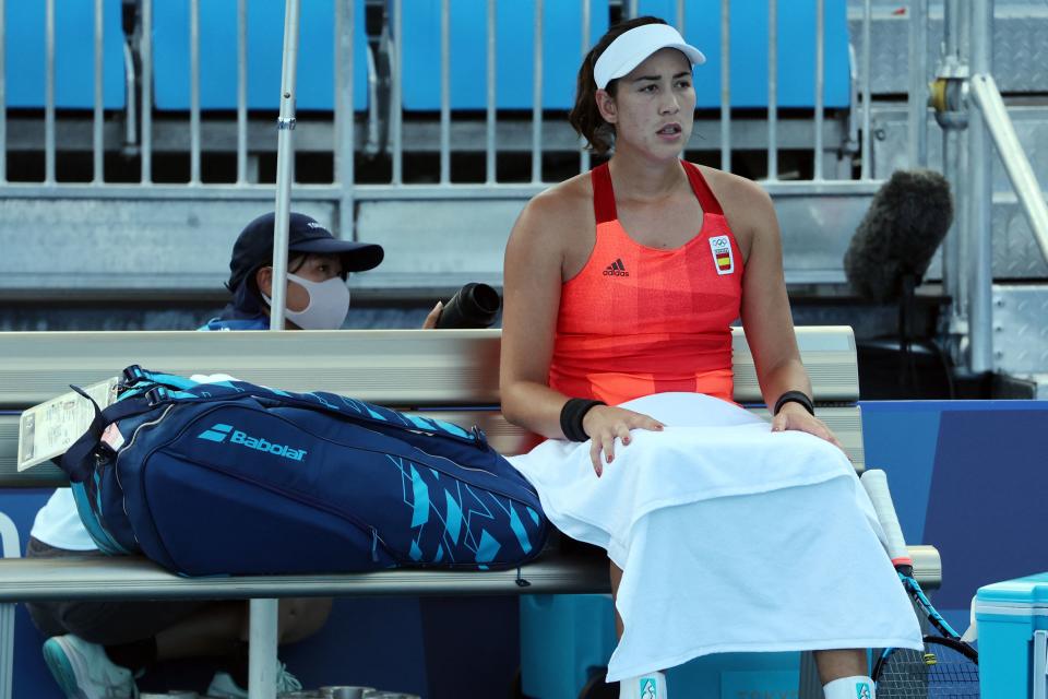 Spain's Garbine Muguruza sits on the bench during her Tokyo 2020 Olympic Games women's doubles third round tennis match against Belgium's Alison van Uytvanck at the Ariake Tennis Park in Tokyo on July 27, 2021. (Photo by Giuseppe CACACE / AFP) (Photo by GIUSEPPE CACACE/AFP via Getty Images)