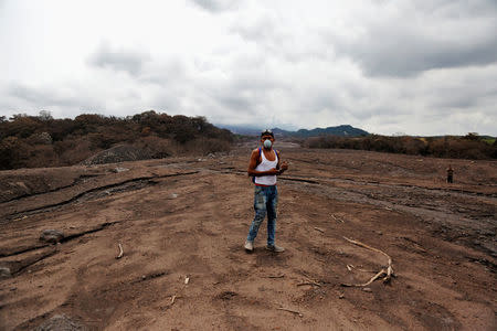 A man walks at an affected area after the eruption of the Fuego volcano in San Miguel, Escuintla, Guatemala, June 8, 2018. REUTERS/Luis Echeverria