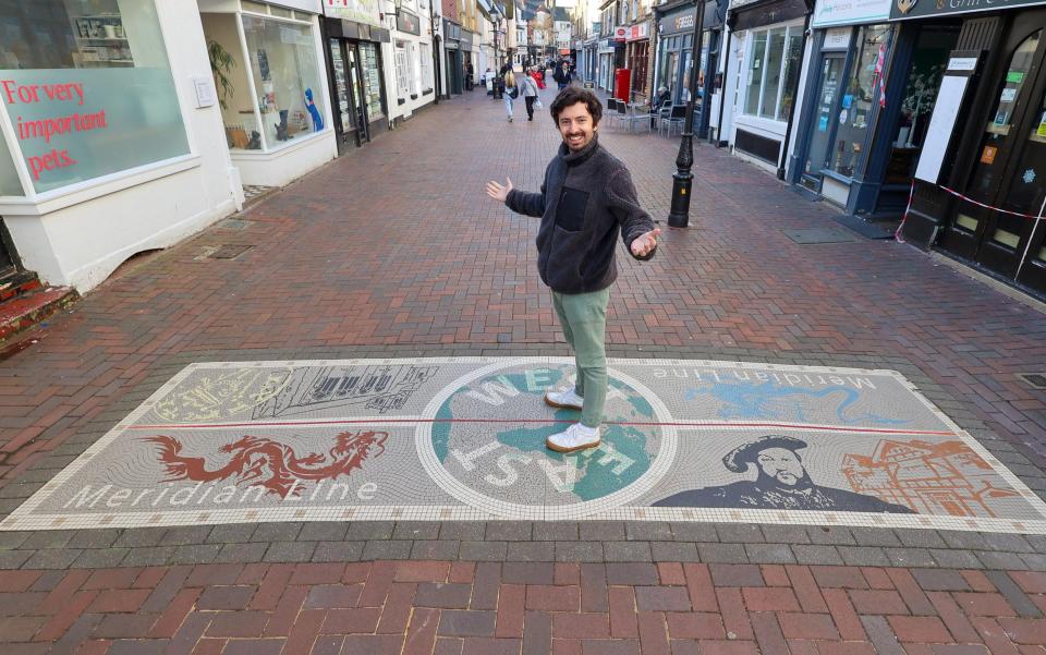 Greg Dickinson stands on the meridian line mosaic in Sun Street