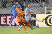 Houston Dynamo forward Darwin Quintero (23) attempts a shot on goal as CF Montreal midfielder Samuel Piette, right, defends and goalkeeper James Pantemis, left, watches during the first half of an MLS soccer match Saturday, Aug. 13, 2022, in Houston. (AP Photo/Michael Wyke)