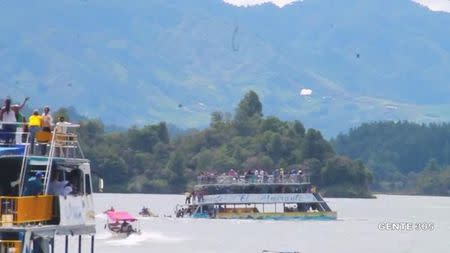 A tourist ferry sinks in the Guatape reservoir in Colombia June 25, 2017 in this still image taken from video obtained from social media. Juan Quiroz/via REUTERS