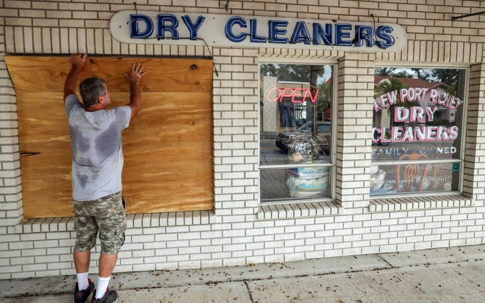 Jay McCoy puts up plywood in preparation for Hurricane Milton in New Port Richey, Florida (AP)