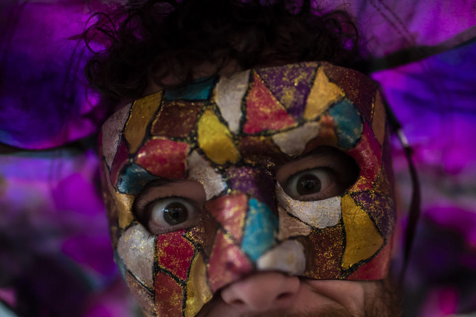 A masked reveler attends a street pre-carnival party by the "Cordao do Boitata" Block, in Rio de Janeiro, Brazil, Sunday, Feb. 12, 2023. Revelers took to the streets for the open-air block parties, leading up to Carnival's official Feb. 17th opening. (AP Photo/Bruna Prado)
