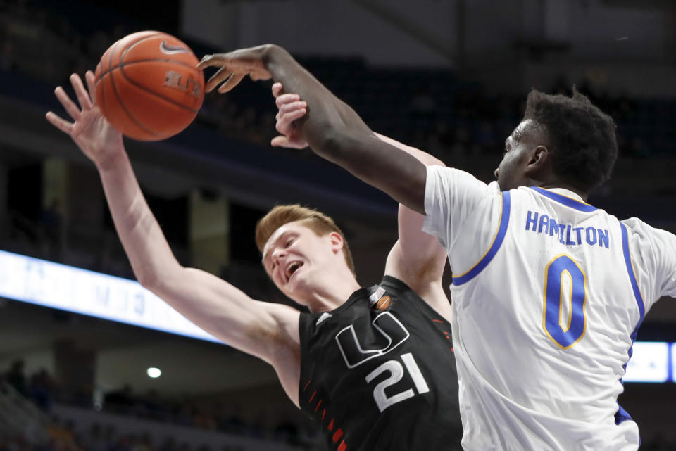 Pittsburgh's Eric Hamilton (0) blocks a shot by Miami's Sam Waardenburg (21) during the first half of an NCAA college basketball game, Sunday, Feb. 2, 2020, in Pittsburgh. (AP Photo/Keith Srakocic)