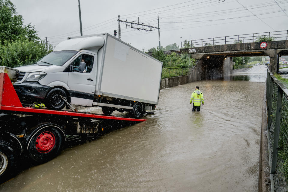 A van is pulled out of a flooded underpass in Oslo following a heavy storm, Monday, Aug. 7, 2023. Stormy weather across the Baltic Sea region Monday caused airport delays, suspended ferry service, minor power outages and lots of rain. (Stian Lysberg Solum/NTB Scanpix via AP)