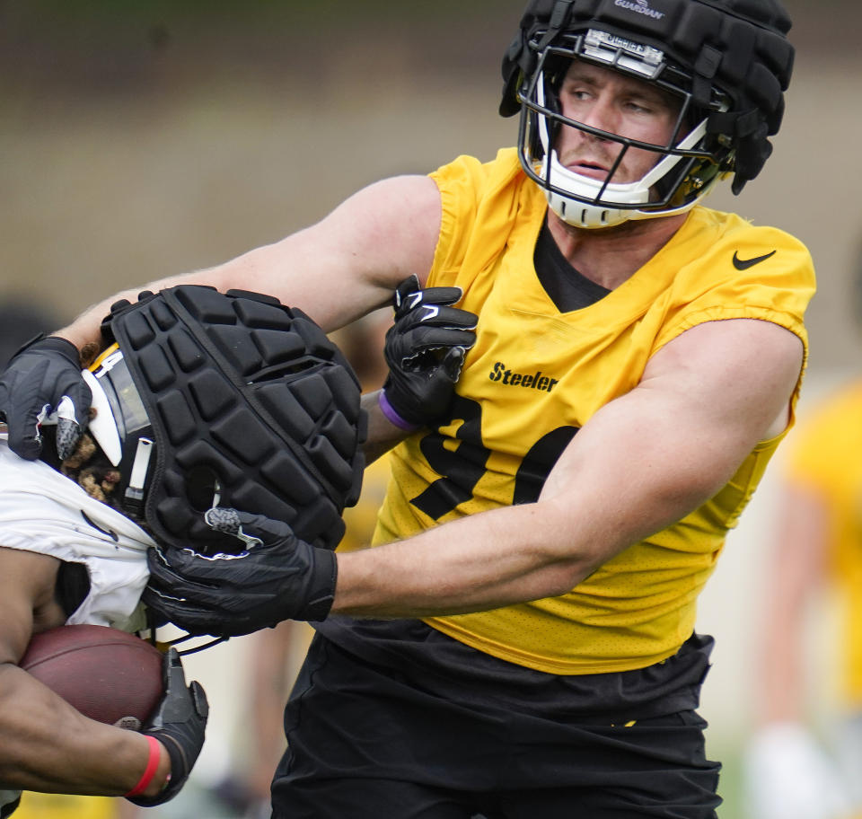 Pittsburgh Steelers linebacker T.J. Watt, right, makes a stop on running back Benny Snell during the NFL football team's training camp in Latrobe, Pa., Wednesday, July 27, 2022. (AP Photo/Keith Srakocic)