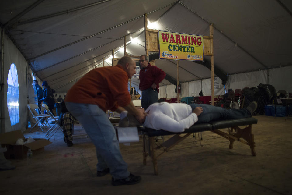 A free massage is given in a warming center tent in the Rockaways, Saturday, Nov. 10, 2012, in the Queens borough of New York. Despite power returning to many neighborhoods in the metropolitan area after Superstorm Sandy crashed into the Eastern Seaboard, many residents of the Rockaways continue to live without power and heat due to damage caused by Sandy. (AP Photo/John Minchillo)