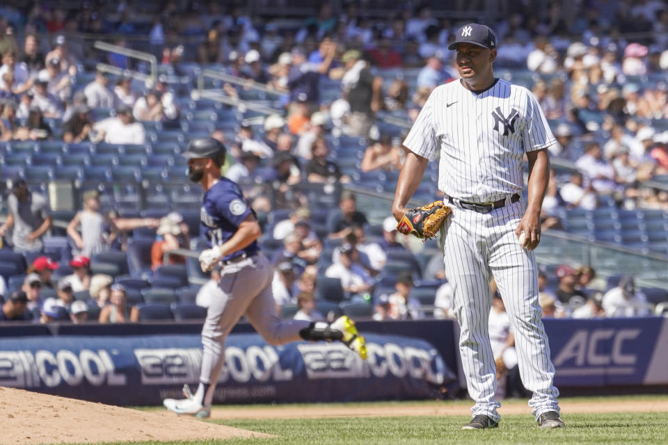 New York Yankees pitcher Wandy Peralta, left, reacts as Seattle Mariners' Jesse Winker runs the bases after hitting a solo home run in the seventh inning of a baseball game, Wednesday, Aug. 3, 2022, in New York. (AP Photo/Mary Altaffer)