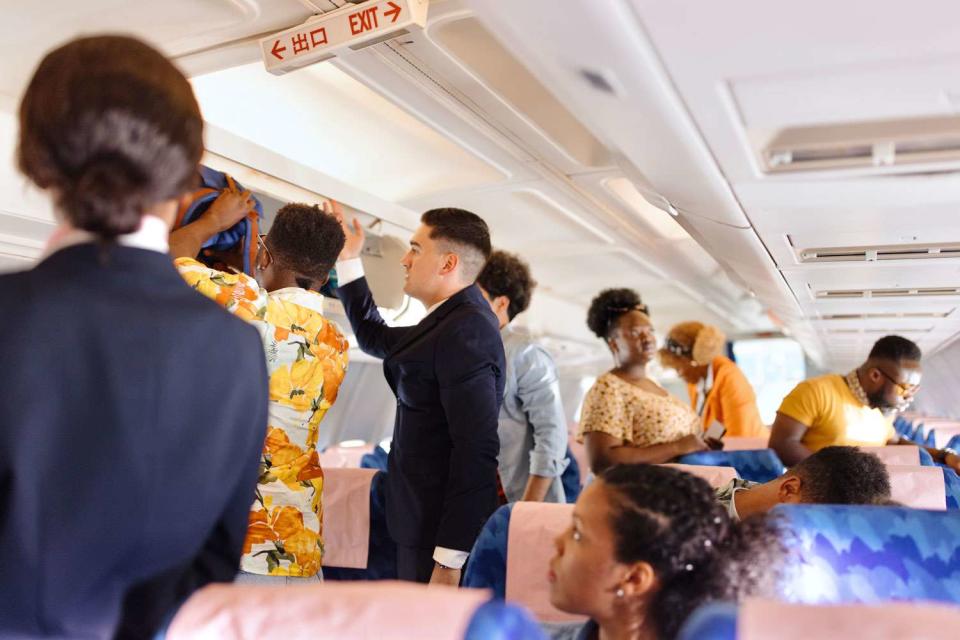 <p>Getty</p> Passengers standing and sitting inside airplane 