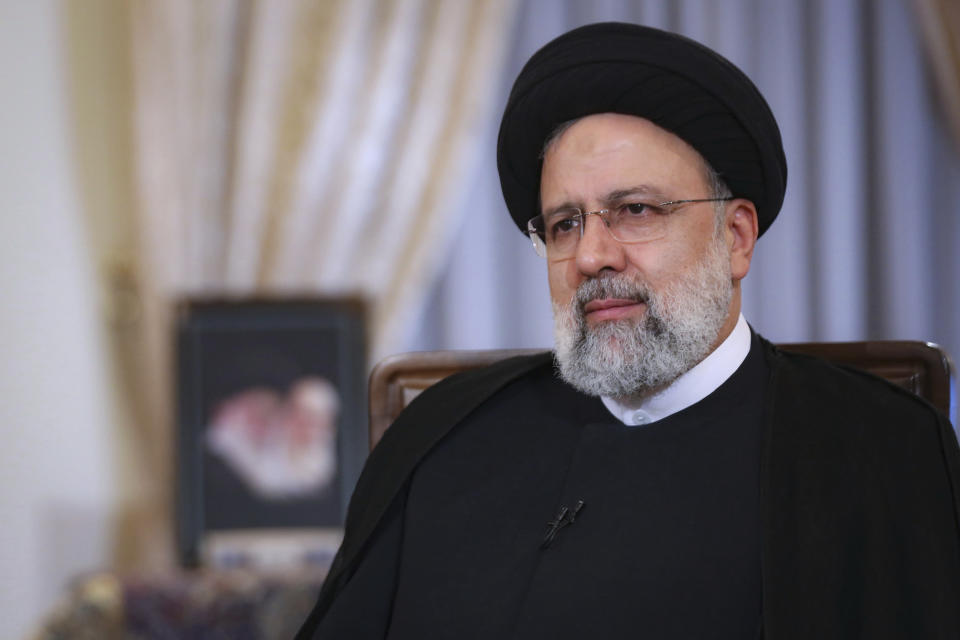 In this photo released by the official website of the office of the Iranian Presidency, President Ebrahim Raisi attends a live interview with state-run TV, at the presidency office in Tehran, Iran, Monday, May 9, 2022. Raisi said the country is exporting twice as much oil as when he took office in August, despite heavy sanctions on oil exports imposed by the U.S. (Iranian Presidency Office via AP)