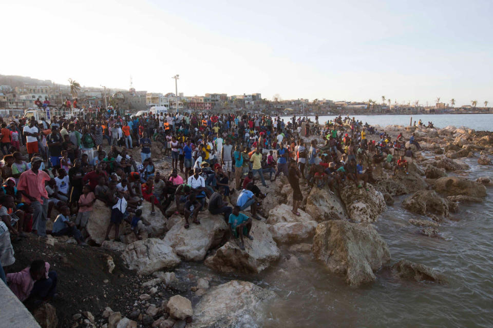 <p>Residents wait on the shore as a boat with water and food from the “Mission of Hope” charity arrives after Hurricane Matthew swept through Jeremie, Haiti, Saturday Oct. 8, 2016. (AP Photo/Dieu Nalio Chery)</p>