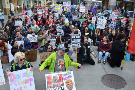 Protestors stop to block an intersection as they march through downtown Seattle in support of Daniel Ramirez Medina, who was detained by U.S. immigration authorities, in Seattle, Washington, U.S. February 17, 2017. REUTERS/David Ryder