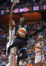 Chicago Sky guard Kahleah Copper drives to the basket as Connecticut Sun forward DeWanna Bonner defends defends during a WNBA semifinal playoff basketball game, Tuesday, Sept. 28, 2021, at Mohegan Sun Arena in Uncasville, Conn. (Sean D. Elliot/The Day via AP)