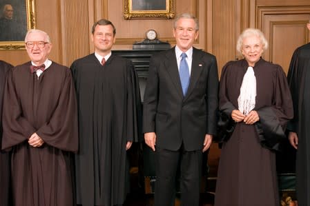 FILE PHOTO: U.S. Chief Justice John Roberts (2nd L) poses for pictures with President George W. Bush (2nd R) and senior Justices John Paul Stevens (L) and Sandra Day O'Connor in the Chief Justice's Conference Room at the Supreme Court in Washington