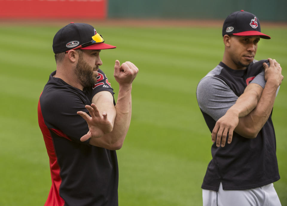 Cleveland Indians' Jason Kipnis, left, and Michael Brantley stretch during a workout in Cleveland, Sunday, Oct. 7, 2018. The Indians are to play the Houston Astros in the third game of their ALDS series Monday. (AP Photo/Phil Long)