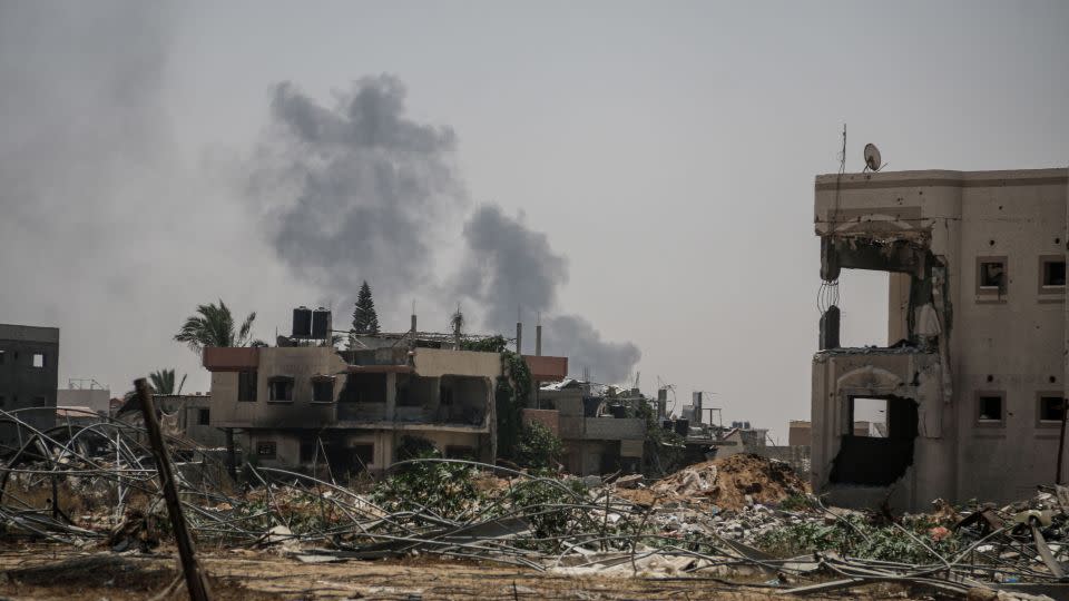 Smoke billows over the rubble of destroyed buildings, after Israeli forces intensified attacks in Khan Younis, southern Gaza, on Monday. - Ahmad Salem/Bloomberg/Getty Images