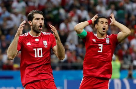 Soccer Football - World Cup - Group B - Iran vs Spain - Kazan Arena, Kazan, Russia - June 20, 2018 Iran's Ehsan Hajsafi and Karim Ansarifard react REUTERS/Toru Hanai