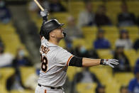 San Francisco Giants' Buster Posey follows through on his three-run home run during the eighth inning of a baseball game against the Los Angeles Dodgers Friday, May 28, 2021, in Los Angeles. (AP Photo/Marcio Jose Sanchez)