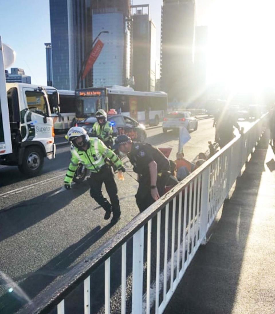 Emergency response personnel drag the canoe from Victoria Bridge in Brisbane.