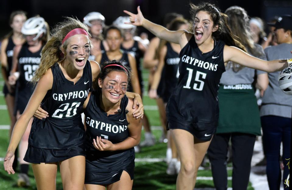 Sickles Gryphons's players, Emma Kilbane (20), Layla Kutno (1) and Maddie Daroch (15) celebrate a 6-5 win    over the Riverview Rams during a playoff game at the Ram Bowl in Sarasota on Friday, April, 22, 2022.