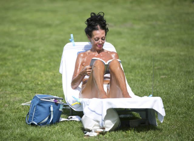 A woman sunbathes