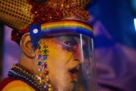 A person wearing a face mask amid of new coronavirus pandemic dances during the Diversity parade in Montevideo, Uruguay, Friday, Sept. 25, 2020. The event is held every year to raise awareness and fight against discrimination based on sexual identity and orientation. (AP Photo/Matilde Campodonico)