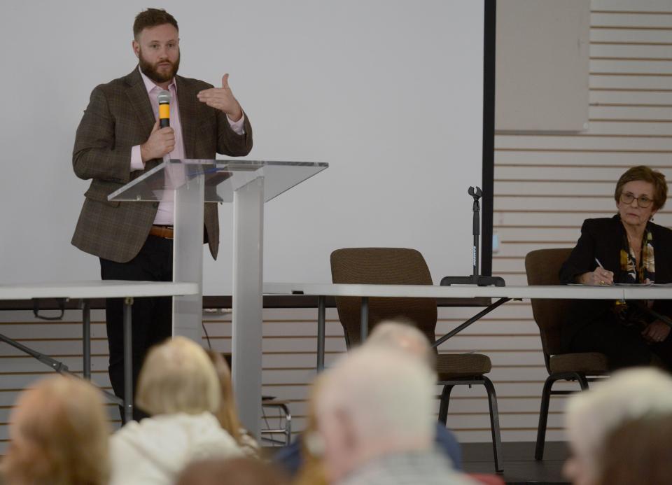 State Sen. Julian Cyr, D-Truro, shares the stage with Cheryl Osimo of the Massachusetts Breast Cancer Coalition on Saturday in Hyannis. A community forum on PFAS was attended by about 75 people including students.