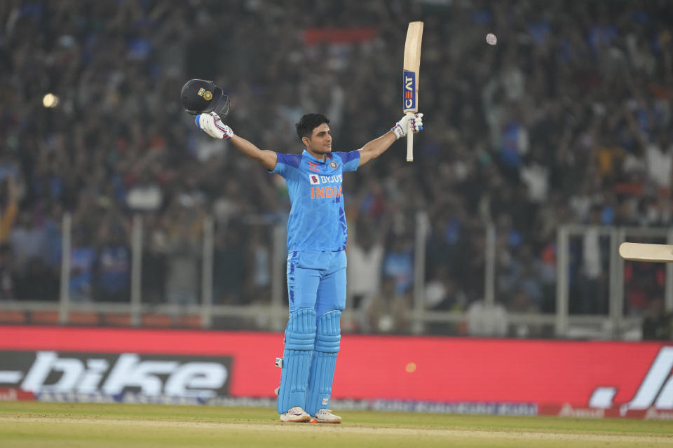 India's Shubhman Gill raises his bat and helmet to celebrate scoring a century during the third T20 international cricket match between India and New Zealand in Ahmedabad, India, Wednesday, Feb. 1, 2023. (AP Photo/Ajit Solanki)