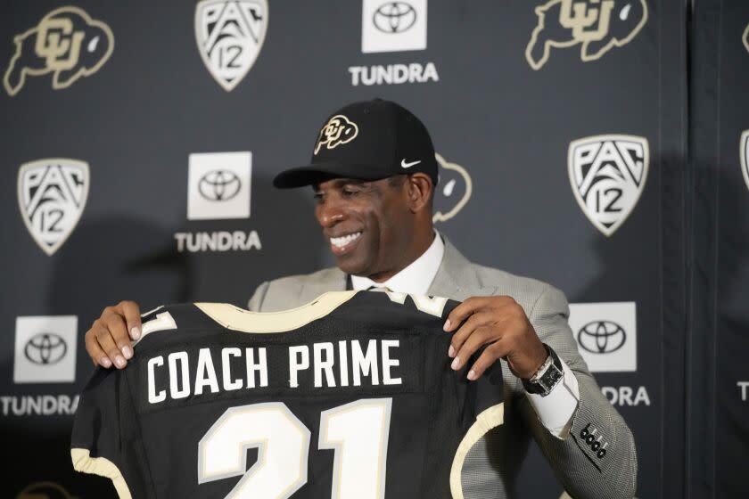 Deion Sanders speaks after being introduced as the new head football coach at the University of Colorado