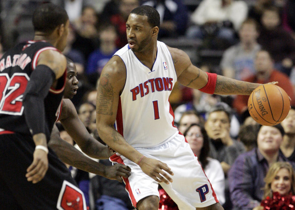 Detroit Pistons guard Tracy McGrady  (R) is pressured by Chicago Bulls guard C.J. Watson (L) and guard Ronnie Brewer (C) during the first half of their NBA basketball game in Auburn Hills, Michigan December 26, 2010.  REUTERS/Rebecca Cook  (UNITED STATES - Tags: SPORT BASKETBALL)