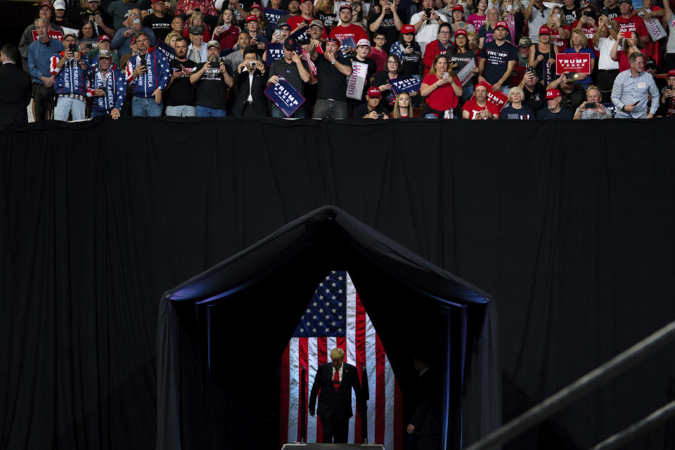 FILE - In this Feb. 19, 2020, file photo President Donald Trump arrives to speak at a campaign rally at Veterans Memorial Coliseum in Phoenix. Trump acknowledged that from early on he was intentionally “playing down” the threat from the coronavirus outbreak that has gone on to kill more than 190,000 Americans. (AP Photo/Evan Vucci, File)