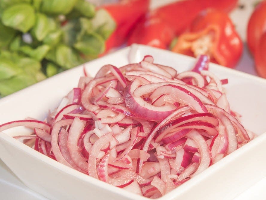 pickled red onion in a white bowl