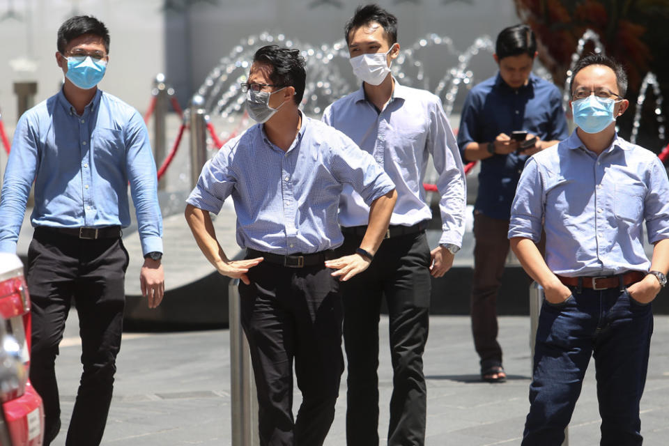 Office workers are seen wearing masks along Jalan Bukit Bintang, Kuala Lumpur March 16 2020. Chief statistician Datuk Seri Mohd Uzir Mahidin warned that if the government failed to address this concern and keep the unemployed busy with new jobs, there could be civil unrest as people struggle to put food on the table. — Picture by Choo Choy May