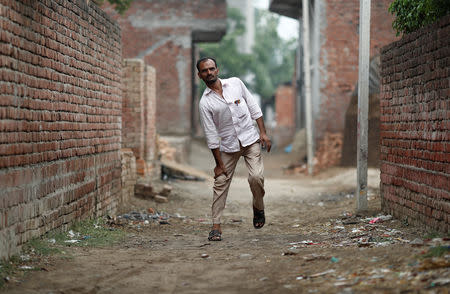 FILE PHOTO: Gulfam Ali, walks in an ally in village Nayabans in the northern state of Uttar Pradesh, India May 15, 2019. REUTERS/Adnan Abidi