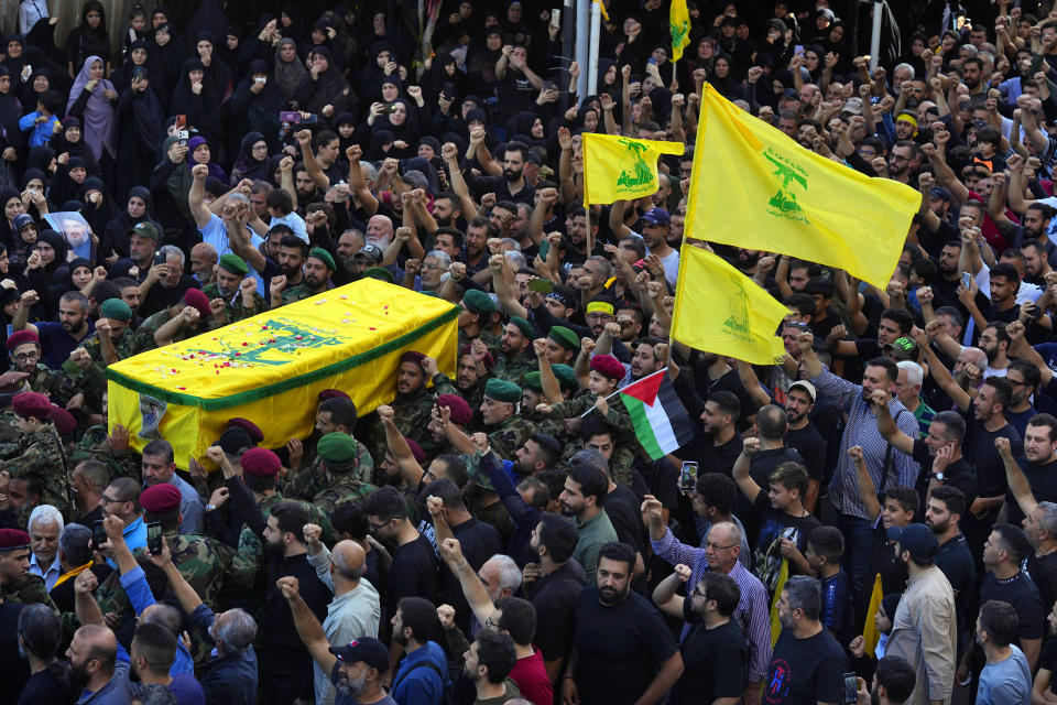 People carry the coffin of Hezbollah fighter, Ali Ibrahim Rmeiti, who was killed by Israeli shelling, during his funeral procession in the southern Beirut suburb of Dahiyeh, Lebanon, Saturday, Nov. 4, 2023. (AP Photo/Bilal Hussein)