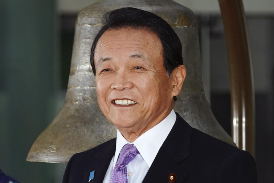 FILE - In this Jan. 6, 2020, file photo, Japan's Finance Minister Taro Aso poses during a ceremony marking the start of this year's trading in Tokyo. Japan's gaffe-prone finance minister Aso came under fire, this time for praising Japan for what he says is the world's only country of single race, language and monarchy that lasted for 2,000 years - a remark that invited criticisms that he neglected Japanese indigenous ethnic group of Ainu and the reality of more racially diverse population elsewhere. (AP Photo/Eugene Hoshiko, File)