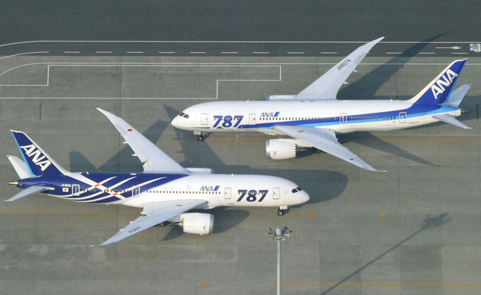 All Nippon Airways Boeing 787 planes sit on a tarmac at Haneda Airport in Tokyo Friday, April 26, 2013. Japan's transport minister said Friday the government is poised to allow Japanese airlines to resume flying grounded Boeing 787s once they complete installation of systems to reduce fire risk in problematic lithium ion batteries. (AP Photo/Kyodo News) JAPAN OUT, MANDATORY CREDIT, NO SALES IN CHINA, HONG KONG, JAPAN, SOUTH KOREA AND FRANCE