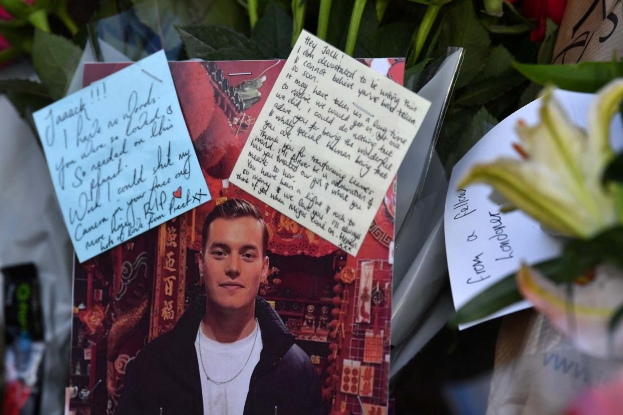 Floral tributes and photographs of the first victim to be named, Jack Merritt: AFP via Getty Images