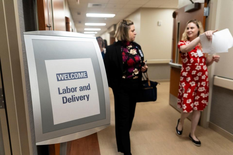 People walk the halls of the newly expanded Women’s Center, which opened Monday.