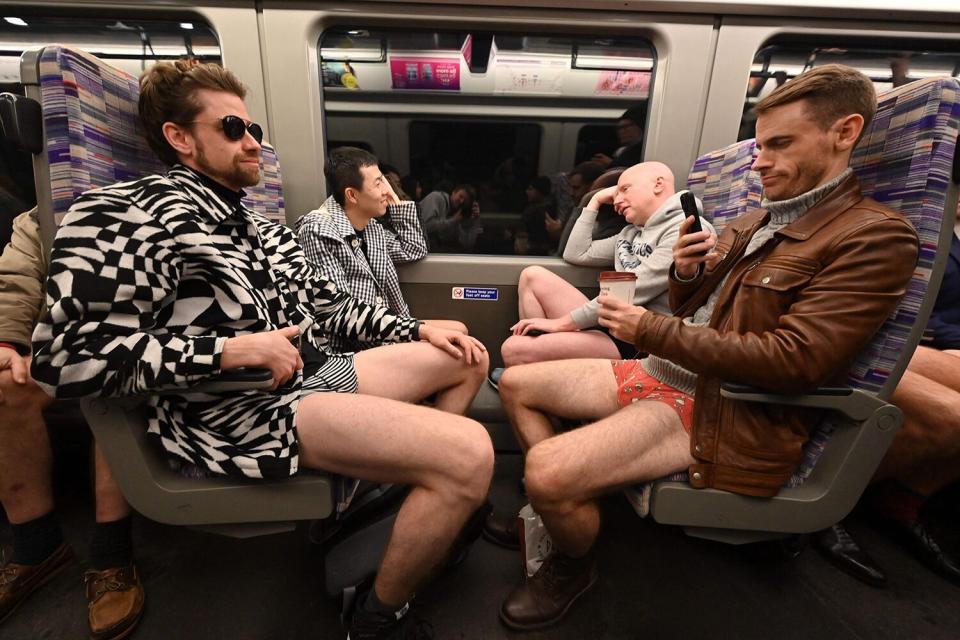 People take part in the annual 'No Trousers On The Tube Day' (No Pants Subway Ride) on the London Underground in central London on January 8, 2023.