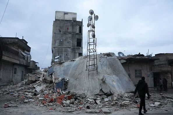 A resident walks along a collapsed building following an earthquake in the town of Jandaris, in the countryside of Syria's northwestern city of Afrin in the rebel-held part of Aleppo province, on February 6, 2023. - Hundreds have been reportedly killed in north Syria after a 7.8-magnitude earthquake that originated in Turkey and was felt across neighbouring countries. (Photo by Rami al SAYED / AFP) (Photo by RAMI AL SAYED/AFP via Getty Images)