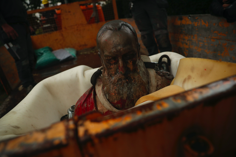 A bust of Belgium's King Leopold II, rests in the back of a truck after being removed from a park. (PA)