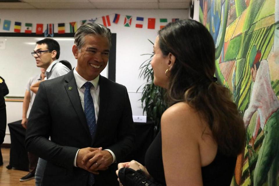 California Attorney General Rob Bonta talks with April Taylor-Salery, Trans-E-Motion board member after the roundtable on hate crimes hosted by Bonta.